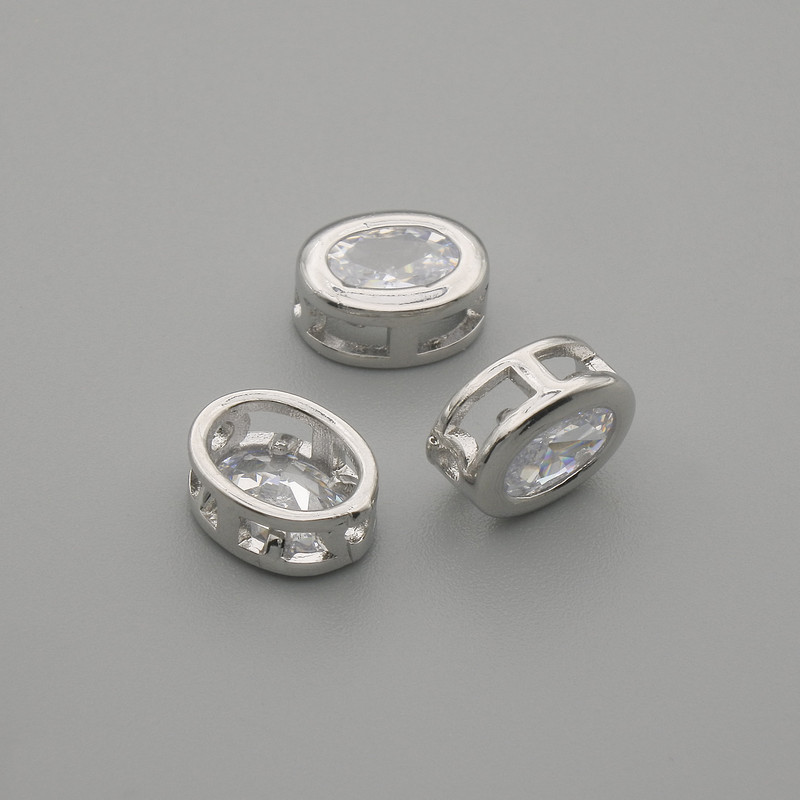 Zapięcie koralik-wkładka z białym kryształem, kolor metalu: srebrny, owalne, średnica 9×7 mm ±, otwór o średnicy 1,3 mm ±, za 1 szt.