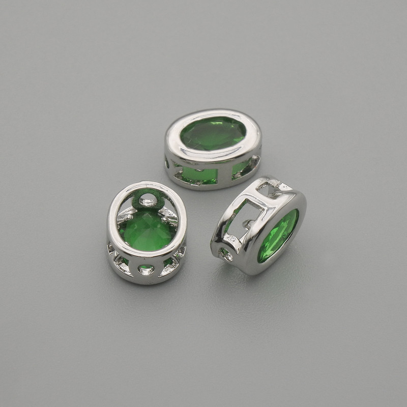 Okucia biżuteryjne, koralik-wkładka z zielonym kryształem, kolor metalu srebrny, owalny, średnica 9×7 mm ±, otwór Ø 1,3 mm ± za 1 szt.