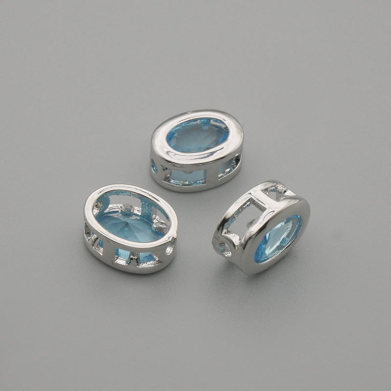 Koralik-wstawka z błękitnym kryształem, kolor metalu: srebrny, owalny, średnica 9×7 mm, otwór średnicy około 1,3 mm, za 1 szt. +