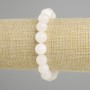 Bransoletka z białego kwarcu — gładkie kulki, średnica około 10 mm, długość około 18 cm, na elastycznej nici