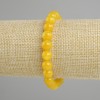 Ta bransoletka z żółtego agatu, gładkie kulki, średnica 8 mm, długość ok. 18 cm, elastyczna