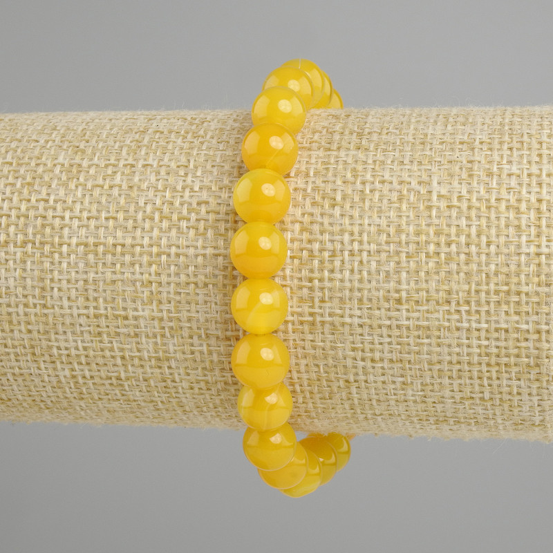 Ta bransoletka z żółtego agatu, gładkie kulki, średnica 8 mm, długość ok. 18 cm, elastyczna