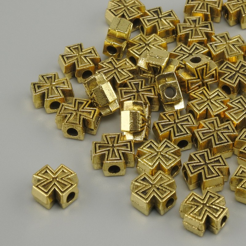 Koralik-wstawka w kształcie krzyża, kolor metalu: żółte złoto, średnica 7×7 mm, otwór 2 mm, pakowanie 20 g (~39 szt.)