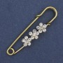 Broszka-spinka z białymi kryształkami strass 48×10 mm ± metal złocisty