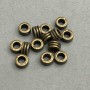 Koralik-oprawka do biżuterii brązowy kolor, średnica 7x4 mm ± otwór, średnica 3, 6 mm ± ~50 szt. +