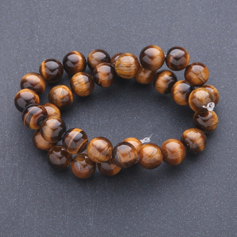 Koraliki z naturalnego kamienia tygrysie oko na nitce, średnica 12 mm, długość 39 cm