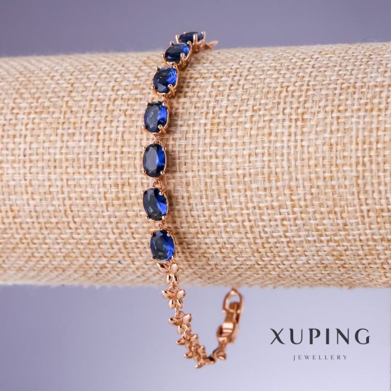 Bransoletka Xuping z niebieskimi cyrkoniami «Szafir», grubość 5 mm, długość 17,5–19,5 cm, pozłacanie 18K