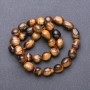 Koraliki z naturalnego kamienia tygrysiego oka fasetowane, średnica 9–12×8 mm, długość 38 cm