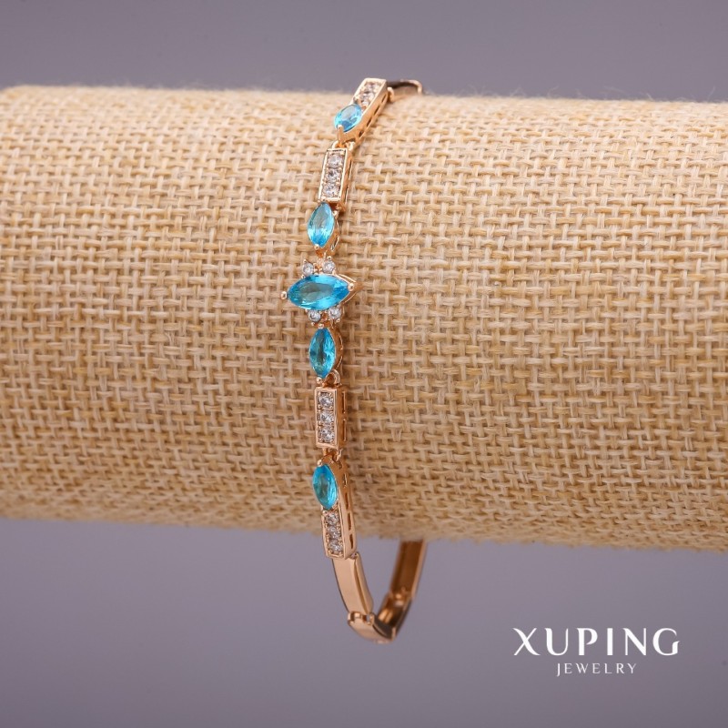 Bransoleta Xuping z kamieniami w kolorze błękitu, grubość 3-9 mm, długość 19 mm, pozłacanie 18k
