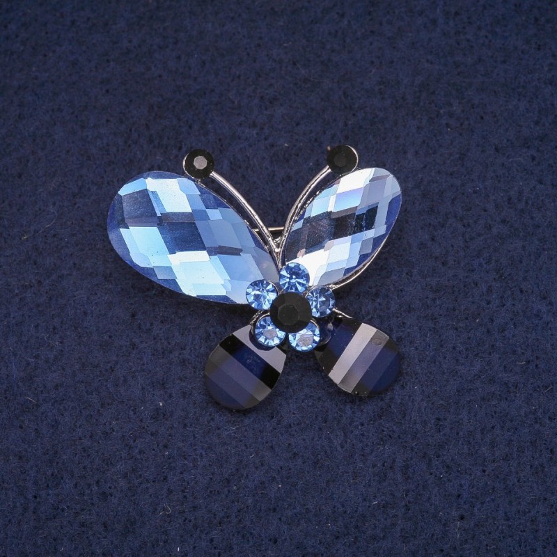 Broszka motyl z niebieskimi i czarnymi kryształami, metal w kolorze srebrnym, 28×32 mm