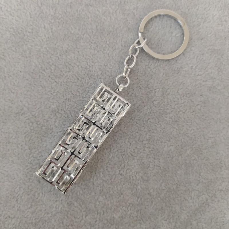 Brelok damski „przesypka” z szarego metalu, średnica 60×20 mm