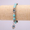 Bransoletka-amulet Turquoise (ręcznie wykonana) z niebieskimi "oczami" na gumce, średnica 12 (+/-) mm, długość 18 cm z wkładkami i zawieszką
