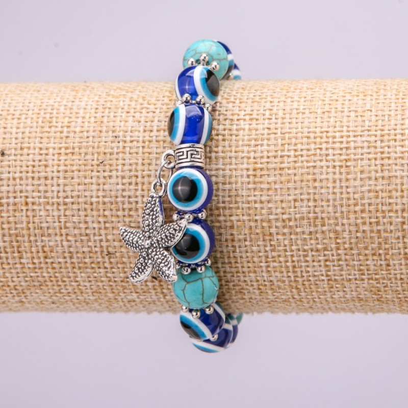 Bransoletka-amulet na gumce turkusem z niebieskimi oczami, średnica 10 mm (±), długość 18 cm z wstawkami i zawieszką 'Gwiazda morska'