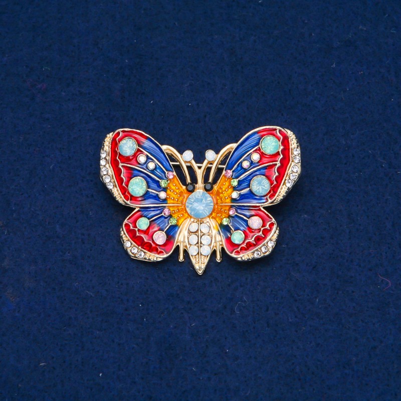 Broszka Motyl z metalu złocistego, emalii i białych, błękitnych, zielono-limonkowych i różowych kryształów 30x45 mm +