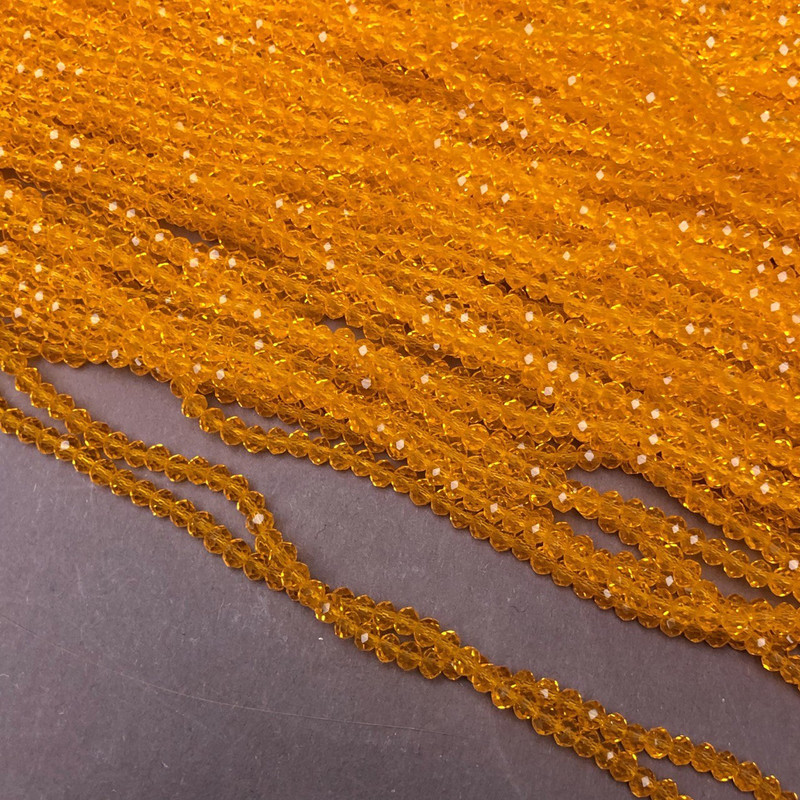 Koraliki z czeskiego kryształu na żyłce w dyniowym odcieniu, przejrzyste, fasetowane rondelki, średnica 3×2,5 mm, długość 36–38 cm
