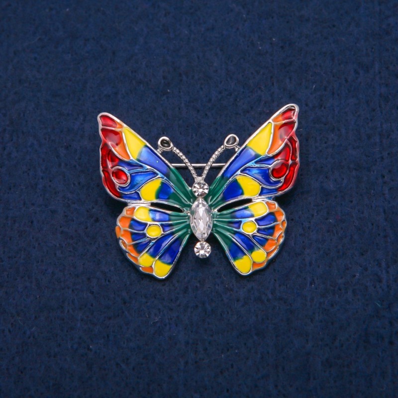 Broszka Motyl z białymi kryształami i różnobarwną emalią, metal złocisty 31×37 mm