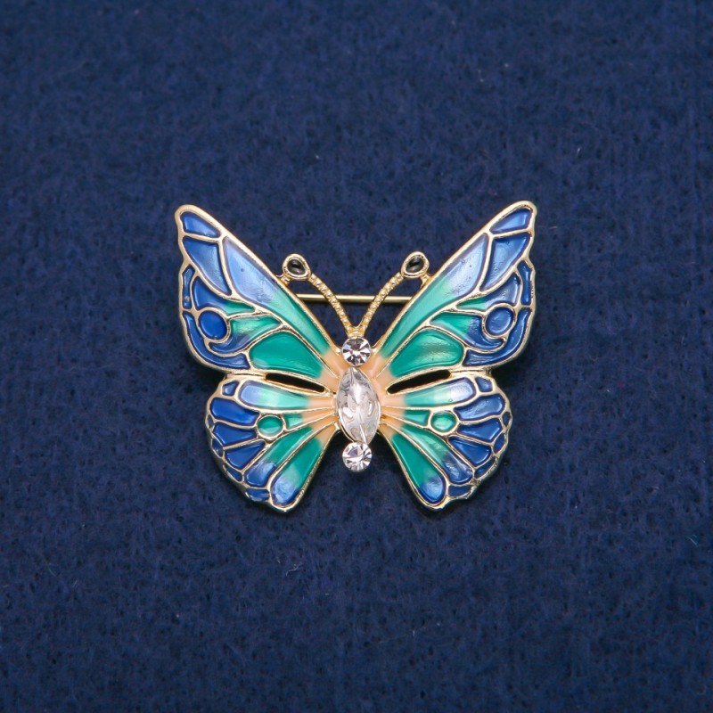 Broszka Motyl z białymi kryształami i różnobarwną emalią, metal złocisty 31×37 mm