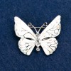 Broszka „Motyl” z białymi kryształami, emalią w kolorze białym i haliozytem, srebrzysty odcień metalu 38×31 mm