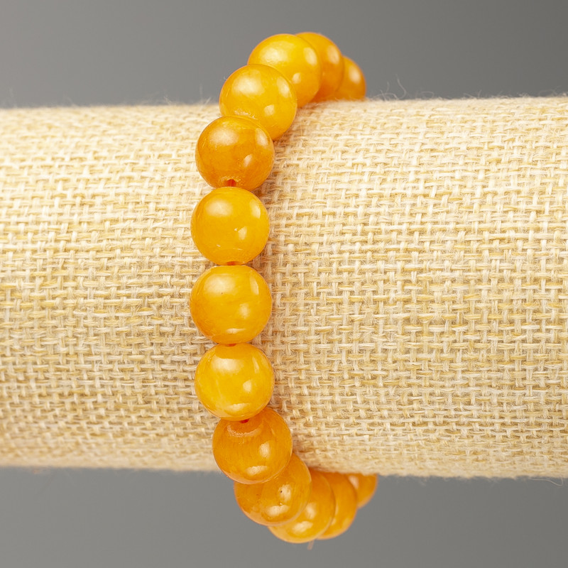 Bransoletka na gumce z imitacją bursztynu (sztuczny akryl) gładka kuleczka, średnica 10 mm, długość 18 cm