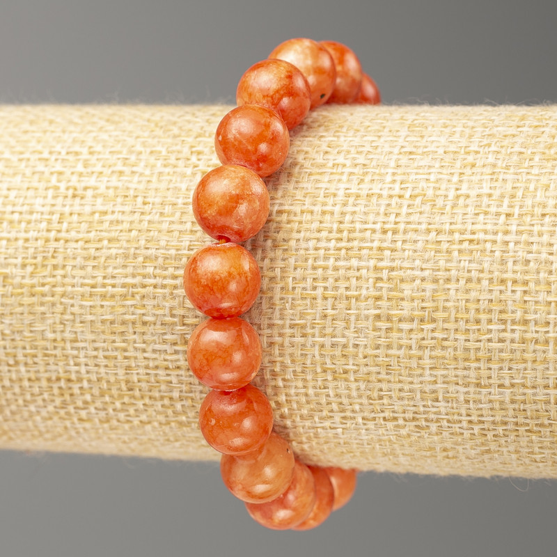 Bransoletka na gumce z karneolem (akryl sztuczny) gładka kulka, średnica około 10 mm, długość 18 cm ±