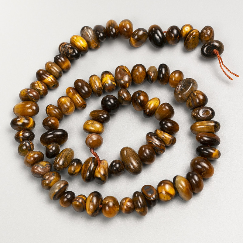 Koraliki z naturalnego kamienia tygrysiego oka na nitce, średnica 11×5 mm ±, długość około 40 cm ±