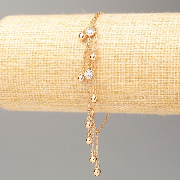 Bransoletka Xuping z pozłoceniem 18K, długość 18–20 cm, grubość około 1,5 mm, z kuleczkami o średnicy 4 mm, z białymi kryształami