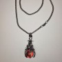 Wisiorek „Kulka w łapie” pomarańczowy, 40×18 mm na łańcuszku, długość około 70 cm, metal srebrzysty