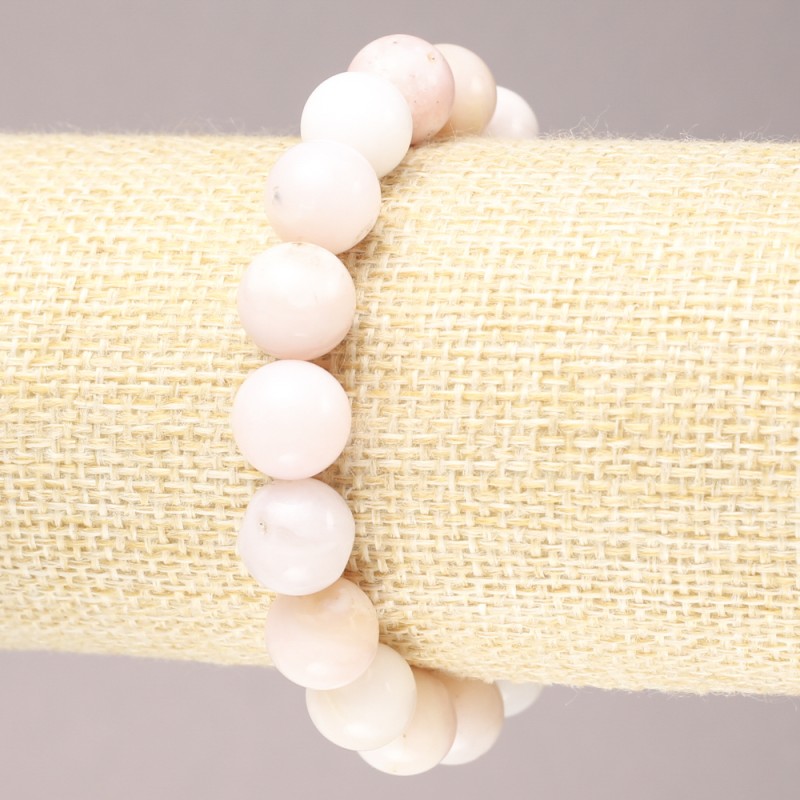 Bransoletka na gumce z naturalnego kamienia – różowy opal, gładka kula, średnica ok. 10 mm