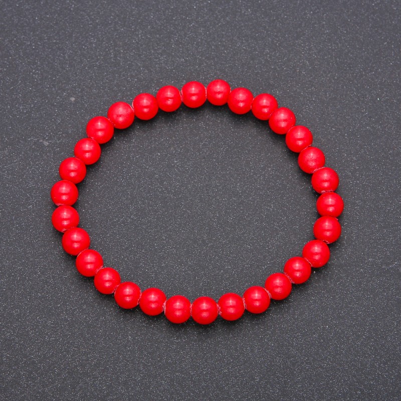 Bransoletka z naturalnego koralu na elastycznej gumce, gładkie kuleczki o średnicy 6 mm (±), długość 18 cm