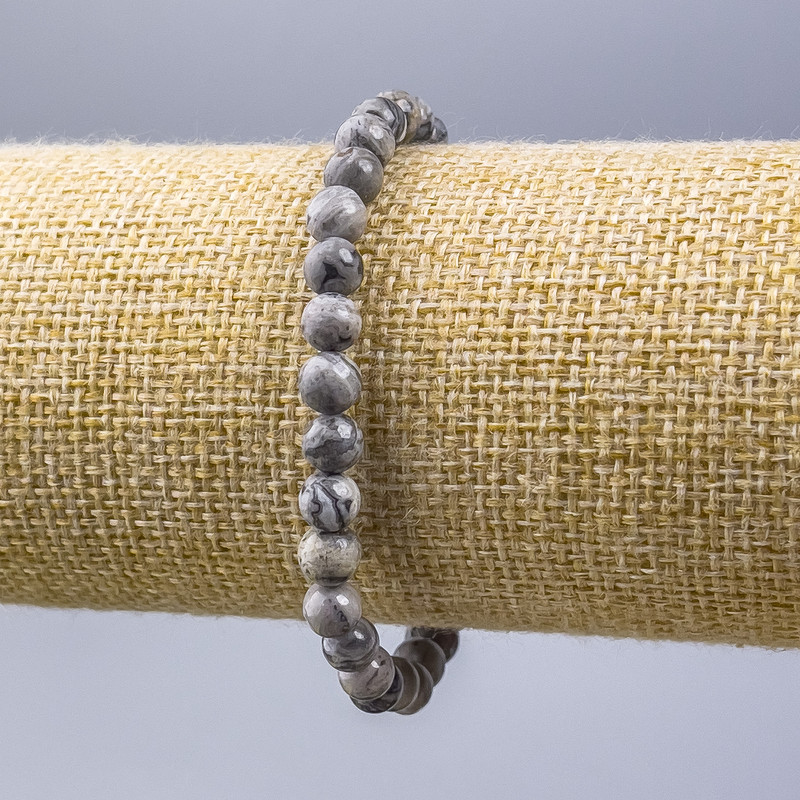 Bransoletka z szarego jaspisu oceanicznego (akryl sztuczny) — gładkie kuleczki o średnicy 6 mm, długość 18 cm (na elastycznej nici)
