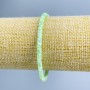 Bransoletka z masy perłowej tonowana jasnozielona, dyski o średnicy 4×2 mm, długość 18 cm (rozciągana)