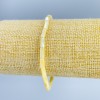 Bransoletka z tonowanej żółtej masy perłowej, dyski o średnicy 4×2 mm, długość 18 cm (rozciągliwa)