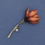 Broszka Kwiat Magnolia – czerwona emalia, czarne cyrkonie, szary koralik, metal złocisty 29×65 mm