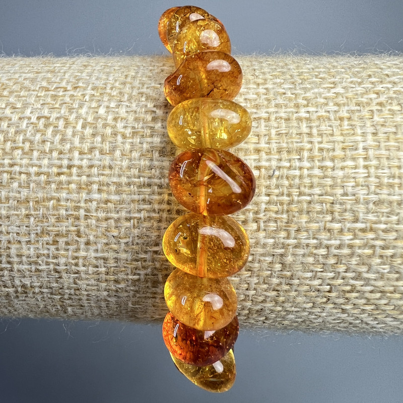 Bransoletka z kryształu pomarańczowa, tonowana na bursztyn, fasetowana, średnica 12×8 mm, długość 18 cm ± (na gumce)