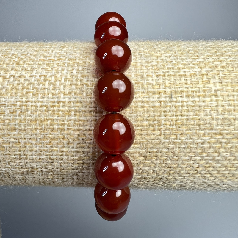 Bransoletka z karneolu, naturalny kamień, gładkie kulki, średnica 10 mm, długość 18 cm (elastyczna)