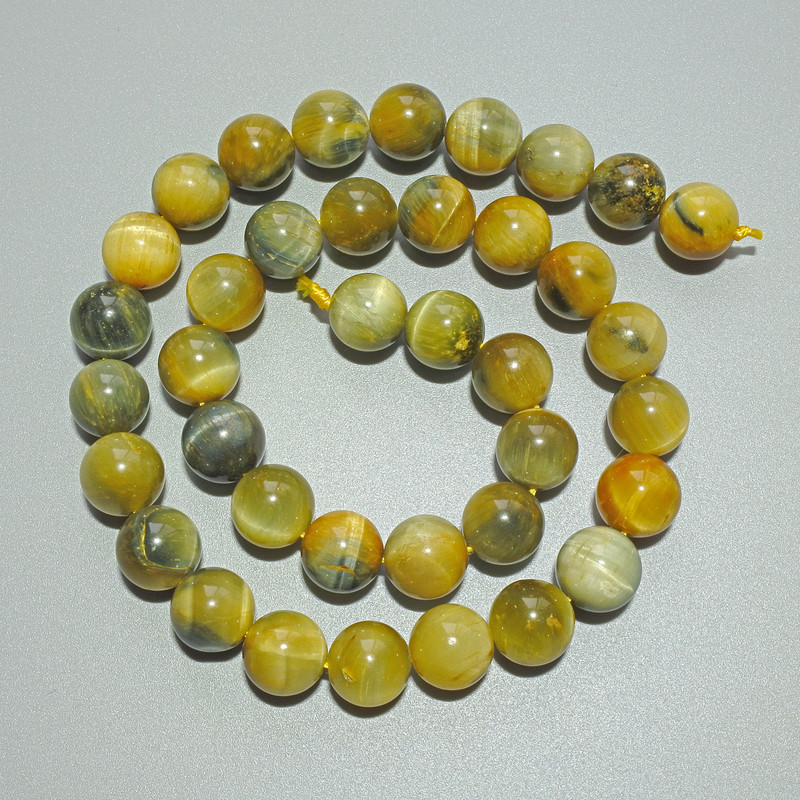 Koraliki z naturalnego kamienia 'Kocie Oko' żółto-szare, gładkie kulki, średnica 10,5 mm, długość 39 cm na nitce