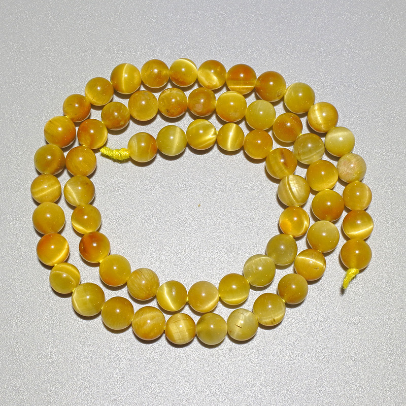 Koraliki Żółte kocie oko z naturalnego kamienia, gładkie kulki, średnica 6,5 mm, długość 38 cm na nitce