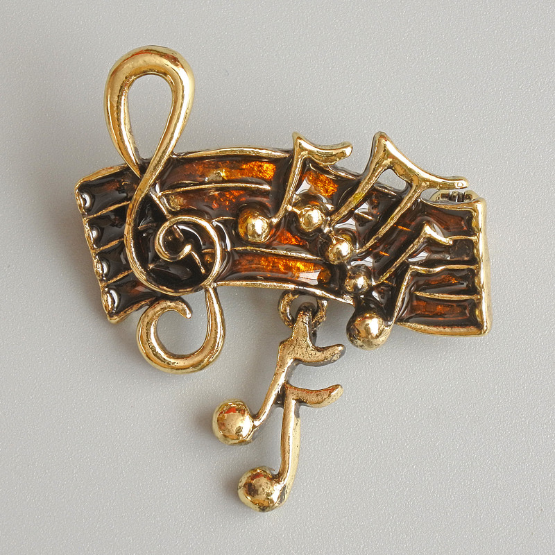 Broszka Nuty brązowa emalia, złocisty metal 33×26 mm