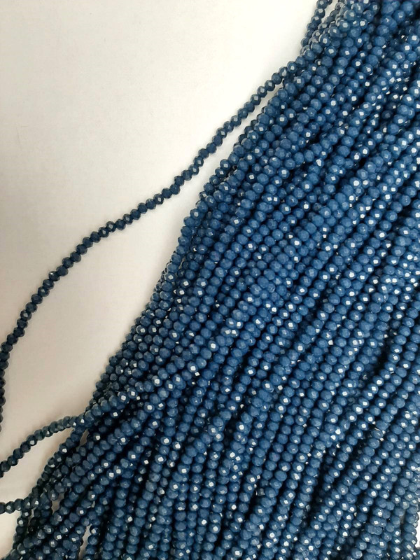 Koraliki czeskiego kryształu w ciemnoniebieskim odcieniu, fasetowane, w kształcie rondelka, średnica 3×2,5 mm, długość 39 mm +/- na żyłce