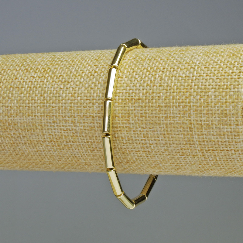 Bransoletka z hematitu w cylindrycznych koralikach koloru jasnego złota, średnica 13×4 mm, długość 18 cm, elastyczna