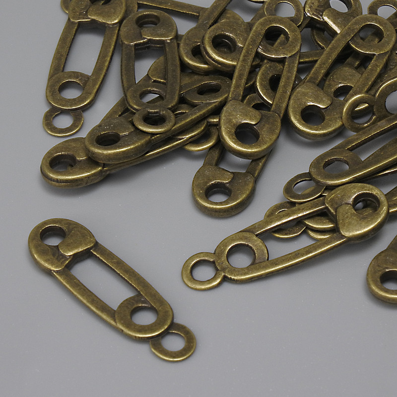 Zawieszka «Szpilka» kolor metalu: brąz, średnica 23×7 mm ± otwór w uszku 2,2 mm ± opakowanie 22 szt.