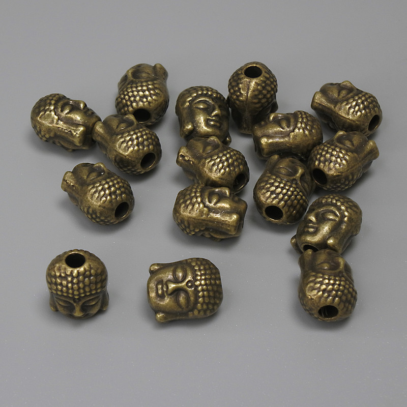 Koralik-wstawka Budda, kolor metalu brązowy, średnica 9×7 mm ± otwór 2,4 mm ± opakowanie 16 szt.