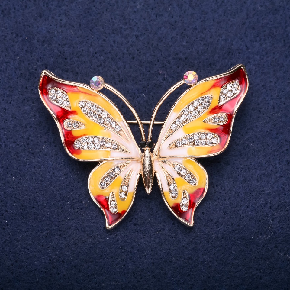 Broszka Motyl z białymi kryształami i emalią czerwono-żółtą, 42×56 mm, metal żółty
