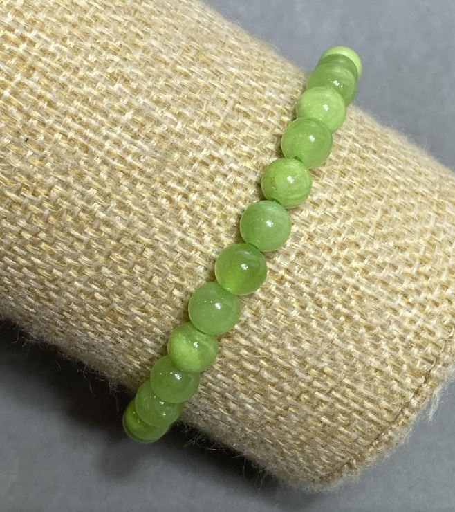 Bransoletka na gumce z naturalnego onyksu, gładka kulka, średnica 6 mm+