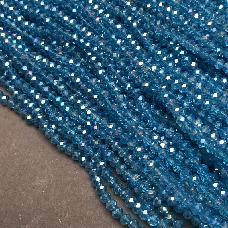 Koraliki czeskiego kryształu na nitce, niebiesko-zielone przejrzyste z efektem benzyny, fasetowane rondele, średnica 3,5×3 mm, długość 36–38 cm