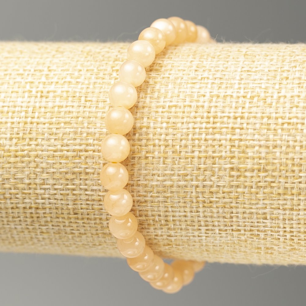 Bransoletka na gumce z akrylowego selenitu, gładkie kuleczki, średnica 6,5 mm, długość 18 cm