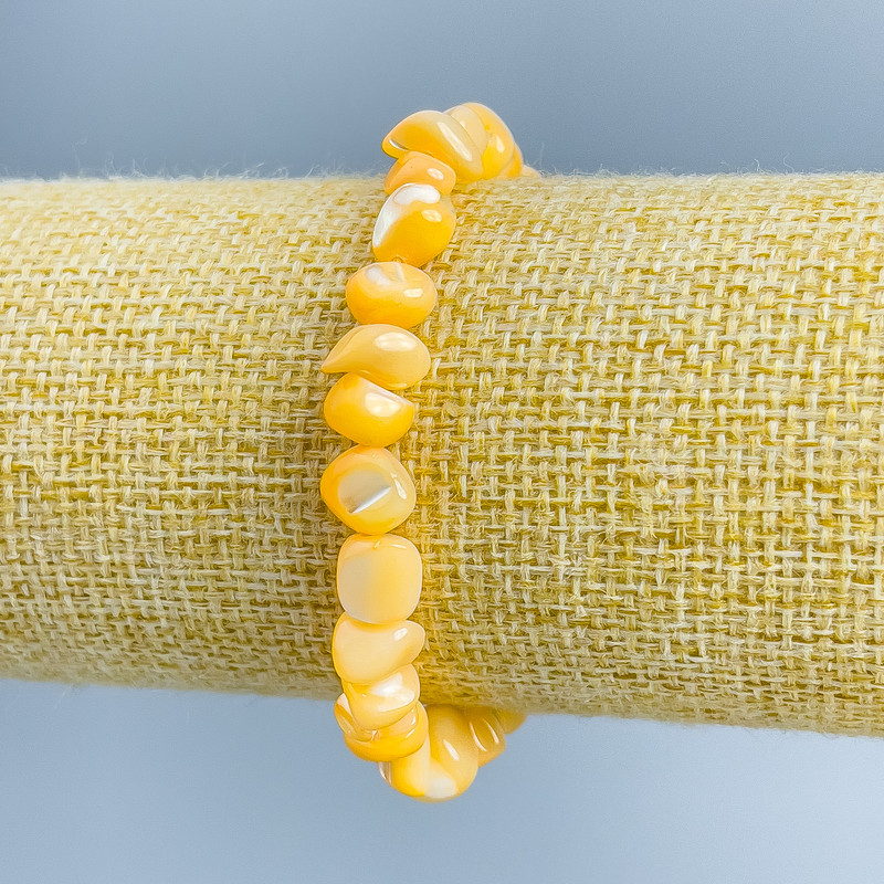 Bransoletka z masy perłowej, jasno-pomarańczowe fasetowane koraliki, średnica 8×6 mm, długość 18 cm (rozciągliwa)