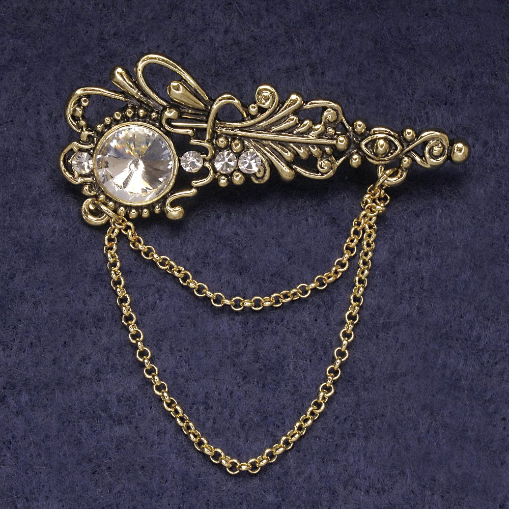 Broszka Akcent z białymi kryształkami i centralnym kryształem, metal złocisty 55×22 mm